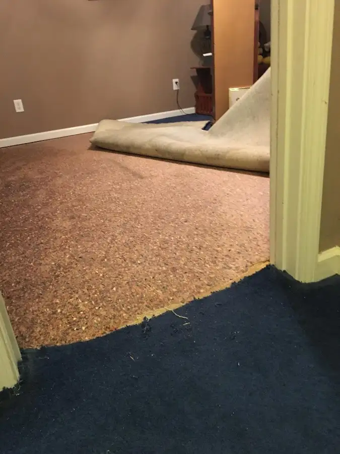 Carpet pad removal revealing water damage during Drying & Dehumidification in Seven Hills